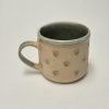 Ceramic mug with green hearts