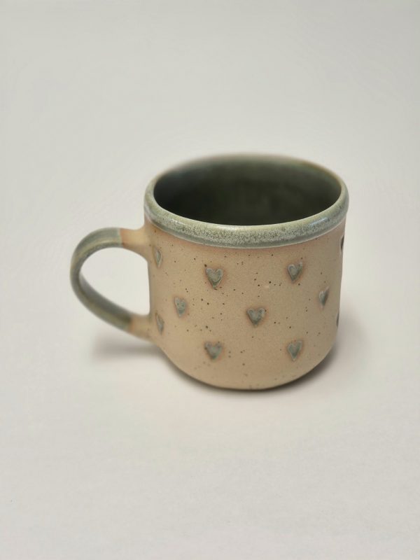 Ceramic mug with green hearts