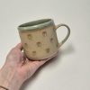 Ceramic mug with green hearts